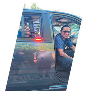 Officer with patrol car header sliding image.