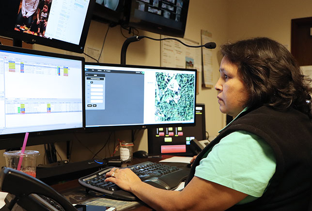 Image of Loreli Ranney, Communications Supervisor, working at a computer terminal