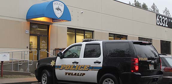 Tulalip Tribal Police Department patrol car in front of Police Department entrance header mobile image. 