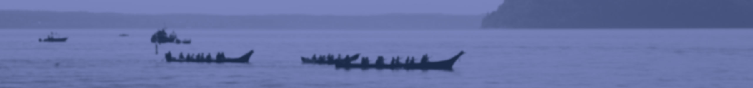 Image of bay with tribal canoes and citizens of Tulalip Tribes background header.