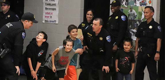 Tulalip Trible Police interacting with children of the community in fun games and social event mobile header.