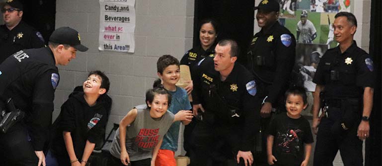 Tulalip Trible Police interacting with children of the community in fun games and social event tablet header.
